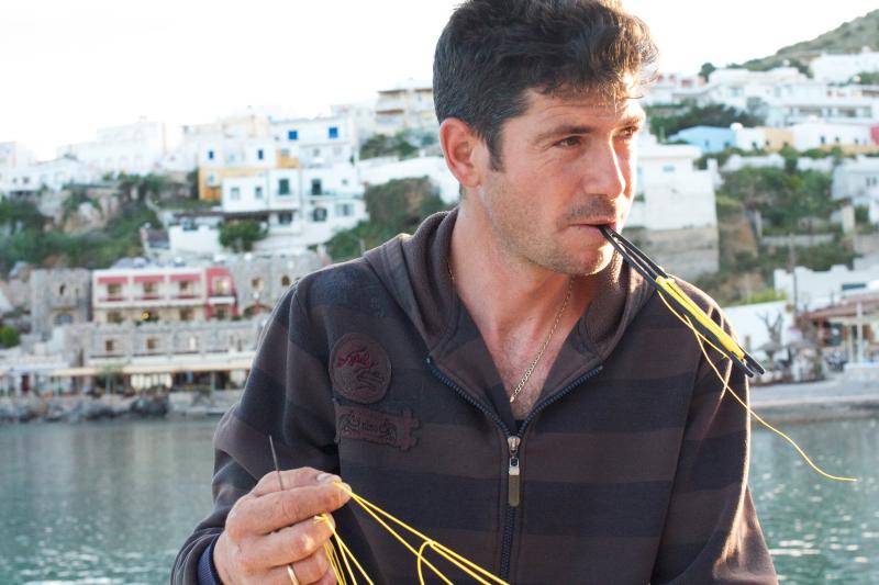 Parisi Tsakirios, 29, mends a net as he prepares for another fishing trip. "I can't imagine doing any other job, because I love the sea," he says. "But there are hardly any fish. I barely break even. I can't support my family." Parisi Tsakirios, 29, mends a net as he prepares for another fishing trip. "I can't imagine doing any other job, because I love the sea," he says. "But there are hardly any fish. I barely break even. I can't support my family."