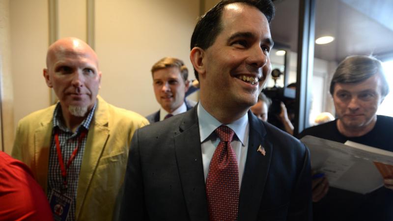 Gov. Scott Walker arrives at the First in the Nation Republican Leadership Summit in New Hampshire. Walker has long been a polarizing figure due to his epic battles with public employee unions, but a new poll this week shows a new and sizable drop in his Gov. Scott Walker arrives at the First in the Nation Republican Leadership Summit in New Hampshire. Walker has long been a polarizing figure due to his epic battles with public employee unions, but a new poll this week shows a new and sizable drop in his