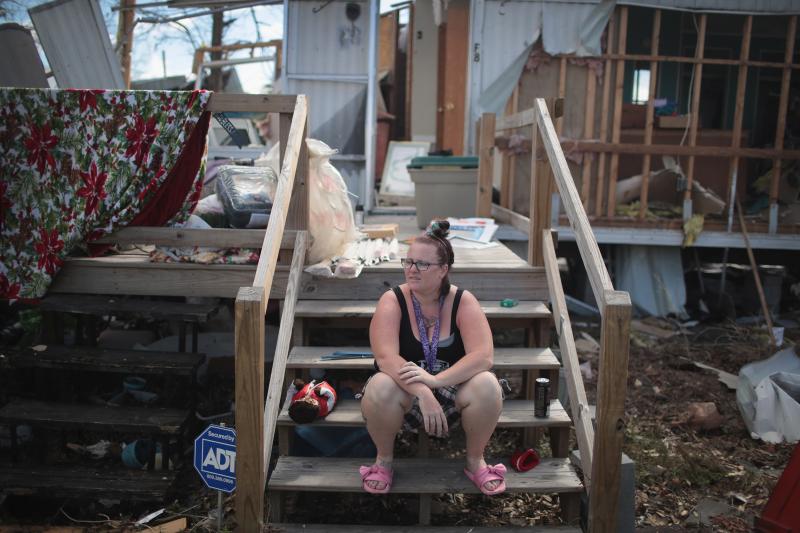 Kimbrely Brock sits on the steps of a friend's trailer that was destroyed by Hurricane Michael in Panama City, Fla., in October. President Trump holds a political rally in Panama City Wednesday. Kimbrely Brock sits on the steps of a friend's trailer that was destroyed by Hurricane Michael in Panama City, Fla., in October. President Trump holds a political rally in Panama City Wednesday.