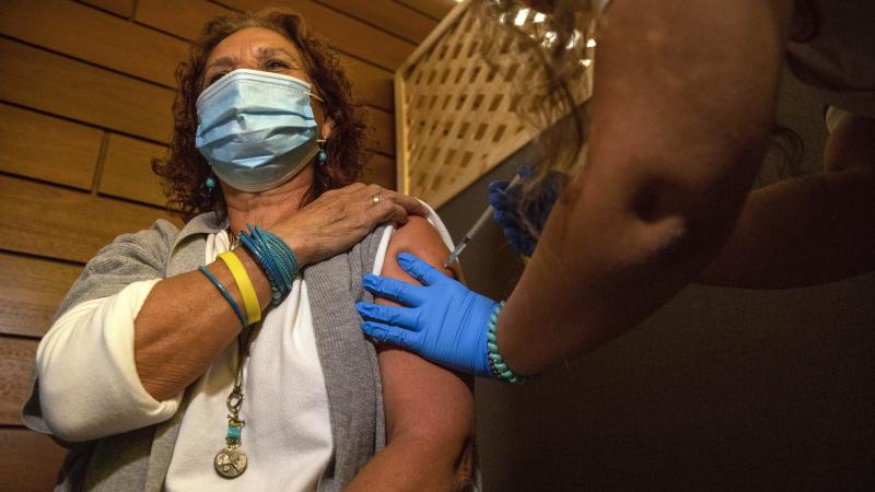 Edna Halup, a staff member at a private nursing home, receives a Pfizer COVID-19 vaccine, in Ganei Tikva, Israel, on Dec. 22. Edna Halup, a staff member at a private nursing home, receives a Pfizer COVID-19 vaccine, in Ganei Tikva, Israel, on Dec. 22.