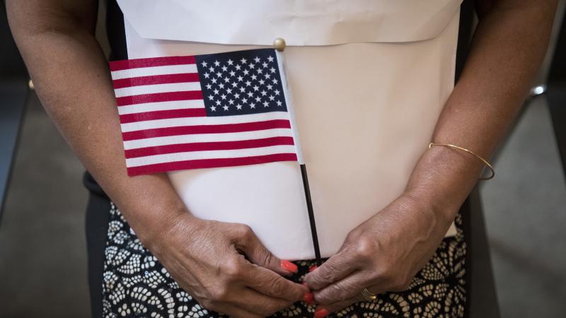 A participant in a 2018 naturalization ceremony holds a U.S. flag in New York City. Research by the Census Bureau suggests the citizenship question is highly likely to scare households with noncitizens from taking part in the constitutionally mandated hea A participant in a 2018 naturalization ceremony holds a U.S. flag in New York City. Research by the Census Bureau suggests the citizenship question is highly likely to scare households with noncitizens from taking part in the constitutionally mandated hea
