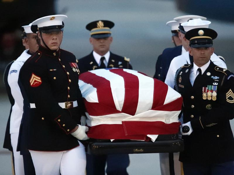 The flag-draped casket of Sen. John McCain, R-Ariz., is carried by an Armed Forces body bearer team to a hearse, on Thursday at Joint Base Andrews, Md. The flag-draped casket of Sen. John McCain, R-Ariz., is carried by an Armed Forces body bearer team to a hearse, on Thursday at Joint Base Andrews, Md.