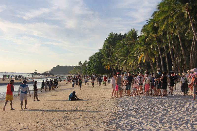 Tourists walk along a beach in Malay town, on the Philippine island Boracay, last week. President Duterte's decision to close Boracay has rocked the island. The Philippines is set to deploy hundreds of riot police to keep travelers out and head off potent Tourists walk along a beach in Malay town, on the Philippine island Boracay, last week. President Duterte's decision to close Boracay has rocked the island. The Philippines is set to deploy hundreds of riot police to keep travelers out and head off potent