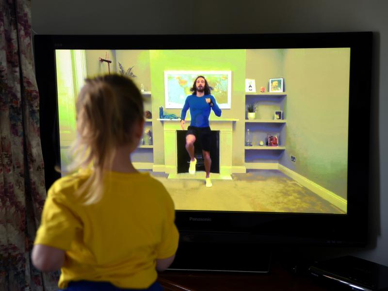 Four-year-old Lois Copley-Jones, the photographer's daughter, takes part in a livestreamed broadcast of "PE With Joe" on March 23, 2020, in Newcastle-under-Lyme, England. The popular fitness series ended Friday. Four-year-old Lois Copley-Jones, the photographer's daughter, takes part in a livestreamed broadcast of "PE With Joe" on March 23, 2020, in Newcastle-under-Lyme, England. The popular fitness series ended Friday.
