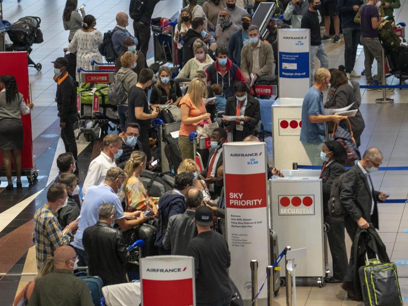 People line up to get on the Air France flight to Paris at OR Tambo's airport in Johannesburg, South Africa, on Nov. 26. The United States, Israel and other European nations have already imposed travel restrictions on South Africa and other nations in the People line up to get on the Air France flight to Paris at OR Tambo's airport in Johannesburg, South Africa, on Nov. 26. The United States, Israel and other European nations have already imposed travel restrictions on South Africa and other nations in the