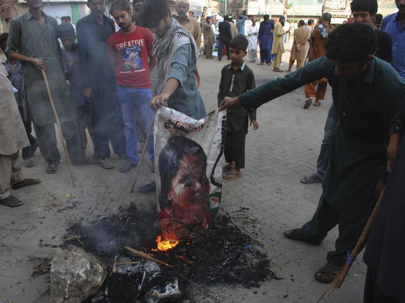Pakistani protesters earlier this month burn a poster depicting Asia Bibi, who spent eight years on death row on blasphemy charges before being acquitted by Pakistan's Supreme Court. Pakistani protesters earlier this month burn a poster depicting Asia Bibi, who spent eight years on death row on blasphemy charges before being acquitted by Pakistan's Supreme Court.