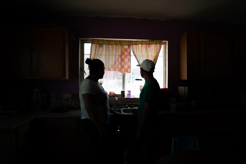 Tania and her husband, Joseph, stand in the kitchen of the space they are sharing with other migrants at a shelter in Juárez, Mexico. She and her husband are from Honduras and are seeking asylum in the U.S. Tania witnessed her mother's slaying back home. Tania and her husband, Joseph, stand in the kitchen of the space they are sharing with other migrants at a shelter in Juárez, Mexico. She and her husband are from Honduras and are seeking asylum in the U.S. Tania witnessed her mother's slaying back home.