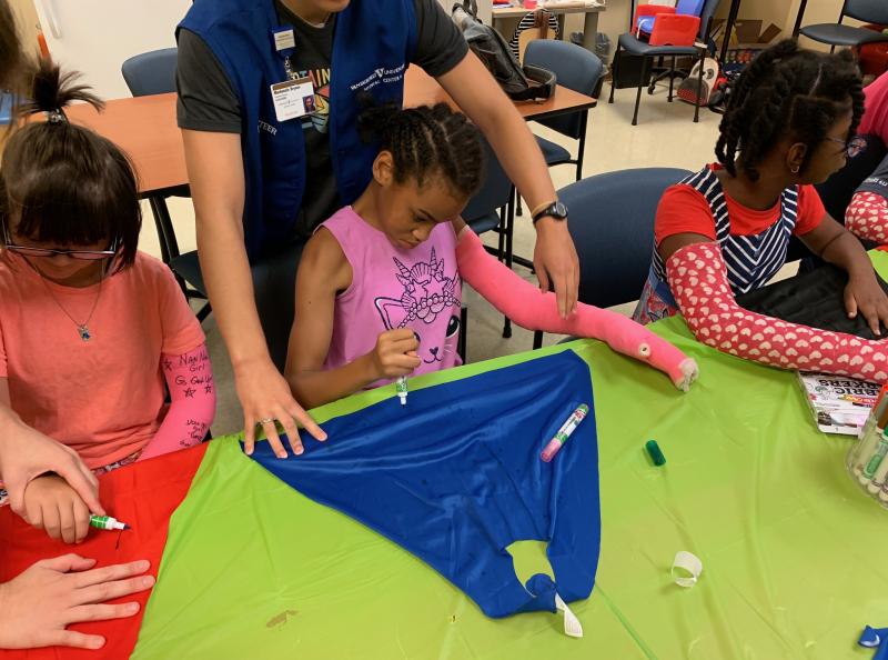 At Nashville's "High Five" camp, 12-year-old Priceless Garinger (center), whose right side has been weakened by cerebral palsy, wears a full-length, bright pink cast on her left arm — though that arm's strong and healthy. By using her weaker right arm a At Nashville's "High Five" camp, 12-year-old Priceless Garinger (center), whose right side has been weakened by cerebral palsy, wears a full-length, bright pink cast on her left arm — though that arm's strong and healthy. By using her weaker right arm a