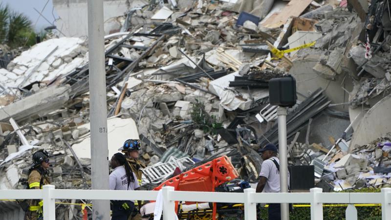 Emergency personnel work at the scene of a collapse of a 12-story condo building in the Surfside area of Miami. Emergency personnel work at the scene of a collapse of a 12-story condo building in the Surfside area of Miami.