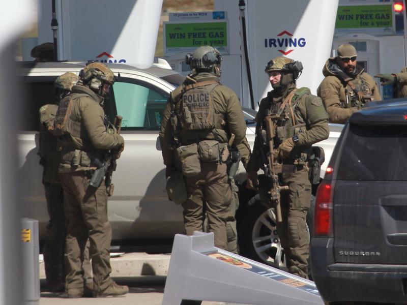 Members of the Royal Canadian Mounted Police (RCMP) tactical unit confer after the suspect in a deadly shooting rampage was killed at a gas station in Nova Scotia, Canada, on Sunday. Members of the Royal Canadian Mounted Police (RCMP) tactical unit confer after the suspect in a deadly shooting rampage was killed at a gas station in Nova Scotia, Canada, on Sunday.