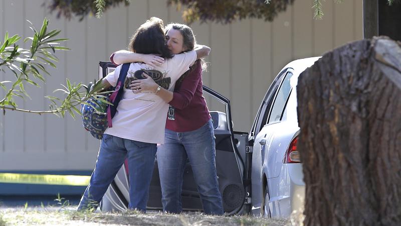 Two women embrace outside Rancho Tehama Elementary School, in Corning, Calif., where a gunman opened fire Tuesday. Two women embrace outside Rancho Tehama Elementary School, in Corning, Calif., where a gunman opened fire Tuesday.