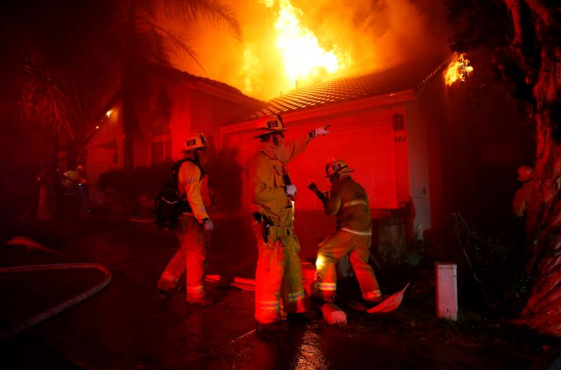 Firefighters try to beat back the Woolsey Fire in the early hours of Friday. One day earlier, the blaze ignited as mourning residents tried to cope with quite another kind of terror in Thousand Oaks, Calif. Firefighters try to beat back the Woolsey Fire in the early hours of Friday. One day earlier, the blaze ignited as mourning residents tried to cope with quite another kind of terror in Thousand Oaks, Calif.