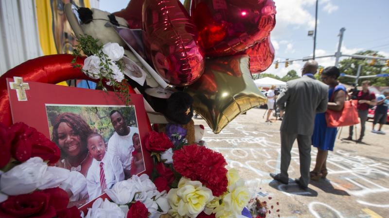 A photo of Alton Sterling and his family is displayed at a memorial outside the Triple S Mart on Thursday in Baton Rouge, La. Sterling was shot by a police officer in front of the convenience store on Tuesday. A photo of Alton Sterling and his family is displayed at a memorial outside the Triple S Mart on Thursday in Baton Rouge, La. Sterling was shot by a police officer in front of the convenience store on Tuesday.