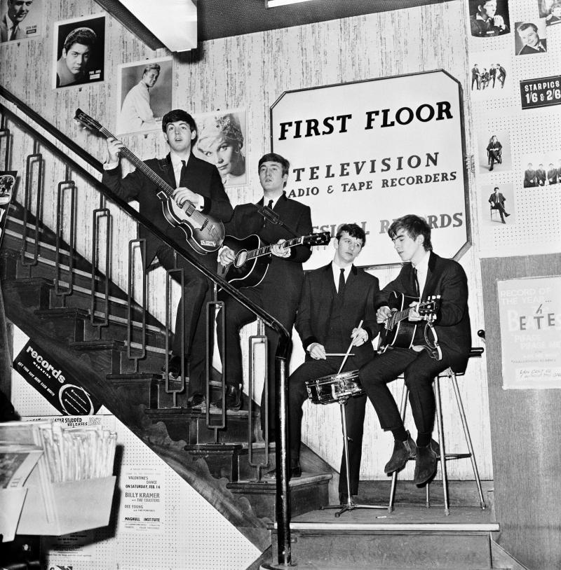 The Beatles on the stairs of NEMS — North End Music Stores, Brian Epstein's Liverpool record shop — having just signed a management deal, in 1964. The Beatles on the stairs of NEMS — North End Music Stores, Brian Epstein's Liverpool record shop — having just signed a management deal, in 1964.