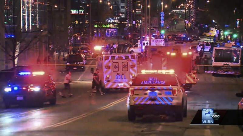 This photo taken from video provided by WISN 12 News shows police responding to the scene of a shooting at Water Street and Juneau Avenue in Milwaukee Friday night. At least 20 people were injured in two shootings. This photo taken from video provided by WISN 12 News shows police responding to the scene of a shooting at Water Street and Juneau Avenue in Milwaukee Friday night. At least 20 people were injured in two shootings.