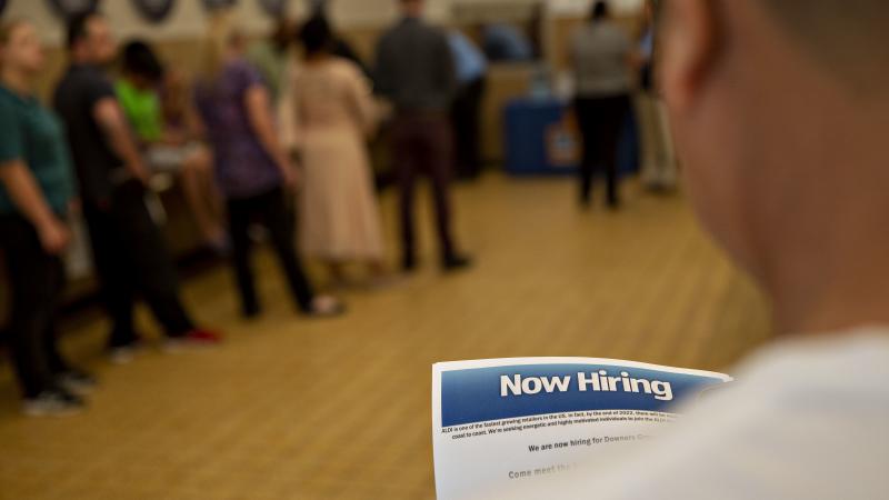 The U.S. has added jobs in every month for nearly eight years. Here, a job seeker holds an employment flyer during a hiring event at an Aldi Supermarket in Darien, Ill., in July. The U.S. has added jobs in every month for nearly eight years. Here, a job seeker holds an employment flyer during a hiring event at an Aldi Supermarket in Darien, Ill., in July.