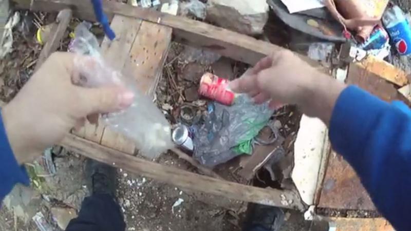 Body camera footage of a Baltimore police operation released by the public defender's office appears to show an officer hiding drugs and later discovering them. Body camera footage of a Baltimore police operation released by the public defender's office appears to show an officer hiding drugs and later discovering them.