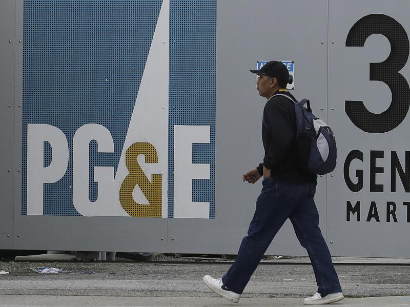 A man walks past a Pacific Gas & Electric Co. entrance in Daly City, Calif. After filing for bankruptcy last month, the company will replace half of its board of directors. A man walks past a Pacific Gas & Electric Co. entrance in Daly City, Calif. After filing for bankruptcy last month, the company will replace half of its board of directors.