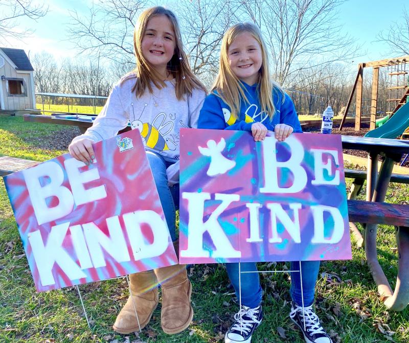 On a November afternoon sisters Raegan and Rylyn Richins sit at their picnic table in their backyard in a Kentucky county holding signs they just painted. On a November afternoon sisters Raegan and Rylyn Richins sit at their picnic table in their backyard in a Kentucky county holding signs they just painted.