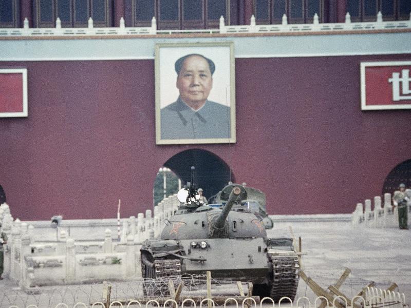 A People's Liberation Army tank sits below a portrait of Mao Zedong at the Gate of Heavenly Peace in Beijing on June 11, 1989, one week after the crackdown on protesters at Tiananmen Square. A People's Liberation Army tank sits below a portrait of Mao Zedong at the Gate of Heavenly Peace in Beijing on June 11, 1989, one week after the crackdown on protesters at Tiananmen Square.