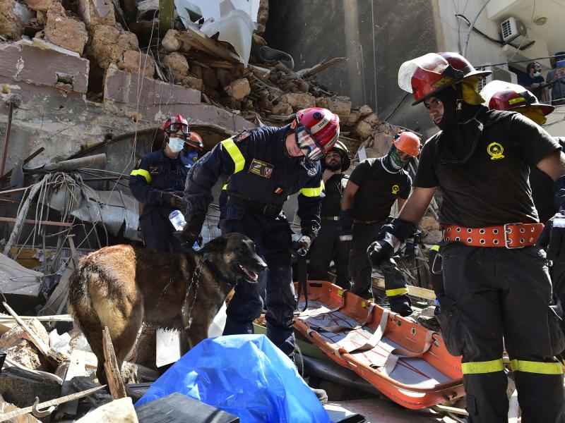 Search and rescue workers sift through damaged buildings Thursday in Beirut after this week's huge explosion at the Lebanese capital's port caused widespread damage. Search and rescue workers sift through damaged buildings Thursday in Beirut after this week's huge explosion at the Lebanese capital's port caused widespread damage.