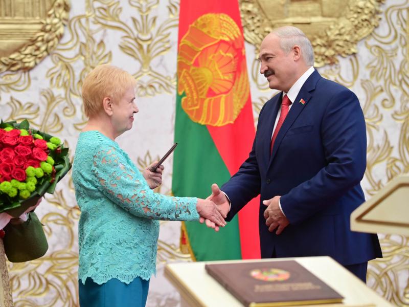 Lidia Yermoshina (left), chairperson of the Belarusian Central Election Commission, hands over a presidential ID to President Alexander Lukashenko during an inauguration ceremony Wednesday at Independence Palace in Minsk. Lidia Yermoshina (left), chairperson of the Belarusian Central Election Commission, hands over a presidential ID to President Alexander Lukashenko during an inauguration ceremony Wednesday at Independence Palace in Minsk.