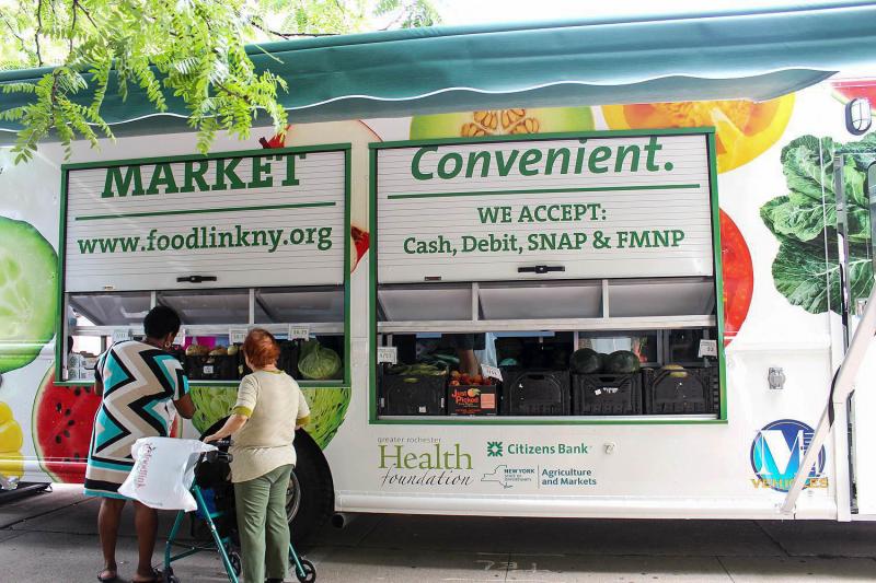 Customers check out the produce at a Curbside Market truck parked at Andrews Terrace, a large apartment complex in downtown Rochester. The program is part of Foodlink's efforts to help poor communities have access to fresh and healthy foods. Customers check out the produce at a Curbside Market truck parked at Andrews Terrace, a large apartment complex in downtown Rochester. The program is part of Foodlink's efforts to help poor communities have access to fresh and healthy foods.