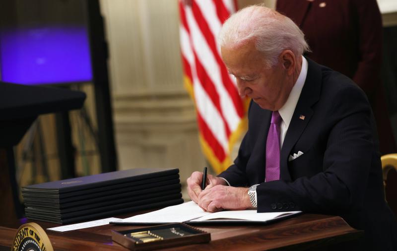President Biden signs an executive order Thursday at the White House. President Biden signs an executive order Thursday at the White House.