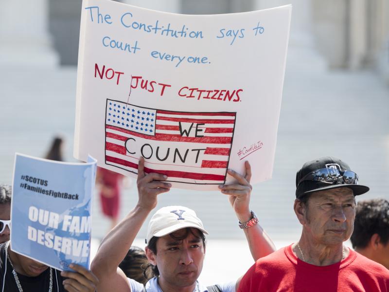 Protesters hold signs about the 2020 census in front of the U.S. Supreme Court in 2019. President-elect Joe Biden is set to reverse the Trump administration's policy of excluding unauthorized immigrants from population numbers used to reallocate congressi Protesters hold signs about the 2020 census in front of the U.S. Supreme Court in 2019. President-elect Joe Biden is set to reverse the Trump administration's policy of excluding unauthorized immigrants from population numbers used to reallocate congressi