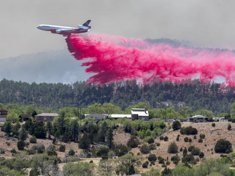 A slurry bomber dumps the fire retardant between the Calf Canyon/Hermit Peak Fire and homes on the westside of Las Vegas, N.M., Tuesday, May 3, 2022. A slurry bomber dumps the fire retardant between the Calf Canyon/Hermit Peak Fire and homes on the westside of Las Vegas, N.M., Tuesday, May 3, 2022.