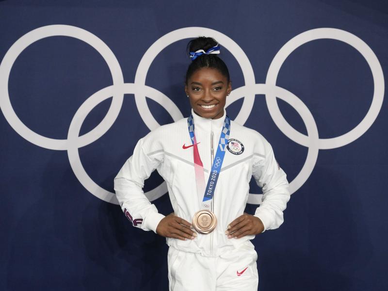 Simone Biles poses wearing her bronze medal from balance beam competition during artistic gymnastics at the Summer Olympics on Aug. 3, 2021, in Tokyo. President Biden will present the Presidential Medal of Freedom to Biles and 16 others at the White House Simone Biles poses wearing her bronze medal from balance beam competition during artistic gymnastics at the Summer Olympics on Aug. 3, 2021, in Tokyo. President Biden will present the Presidential Medal of Freedom to Biles and 16 others at the White House
