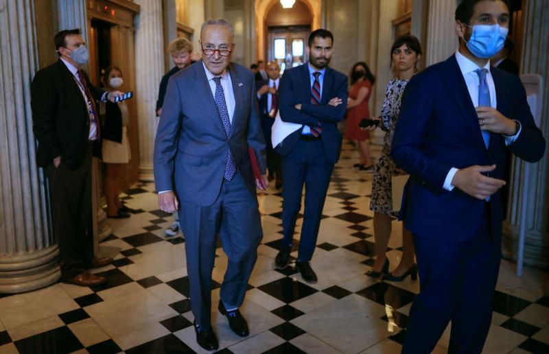 Senate Majority Leader Chuck Schumer, D-N.Y., walks off the Senate floor Wednesday during a procedural vote on the bipartisan infrastructure bill that ultimately failed. Senate Majority Leader Chuck Schumer, D-N.Y., walks off the Senate floor Wednesday during a procedural vote on the bipartisan infrastructure bill that ultimately failed.