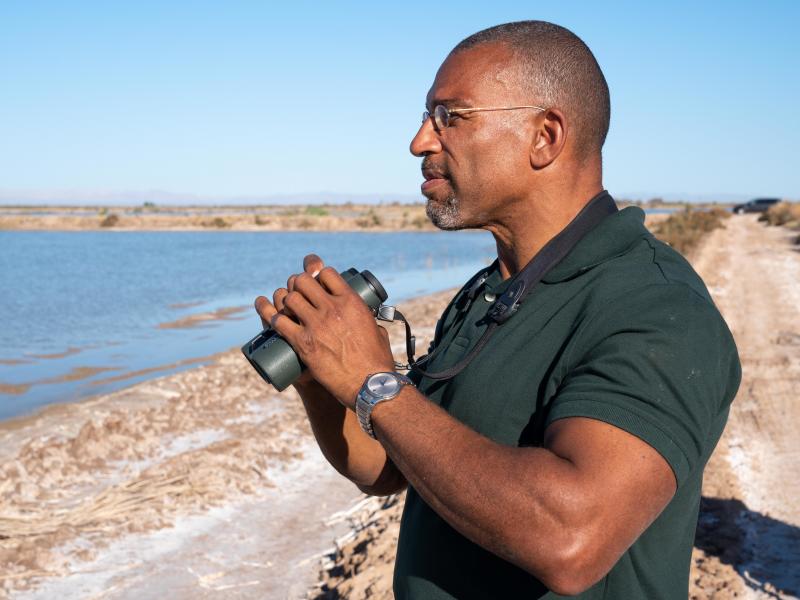 Christian Cooper watches distant shorebirds at the Sonny Bono Salton Sea National Wildlife Refuge in California. The National Geographic channel has announced that Cooper will host a series called Extraordinary Birder. Cooper was in the spotlight after a Christian Cooper watches distant shorebirds at the Sonny Bono Salton Sea National Wildlife Refuge in California. The National Geographic channel has announced that Cooper will host a series called Extraordinary Birder. Cooper was in the spotlight after a