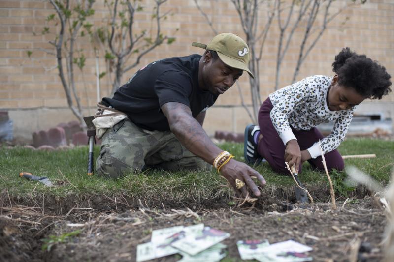Ietef "DJ Cavem Moetavation" Vita plants seeds with daughter Libya LeaDonvita in the garden at their home outside Denver. Vita is among a growing list of Black gardening enthusiasts-turned-entrepreneurs across the country who've launched seed businesses d Ietef "DJ Cavem Moetavation" Vita plants seeds with daughter Libya LeaDonvita in the garden at their home outside Denver. Vita is among a growing list of Black gardening enthusiasts-turned-entrepreneurs across the country who've launched seed businesses d