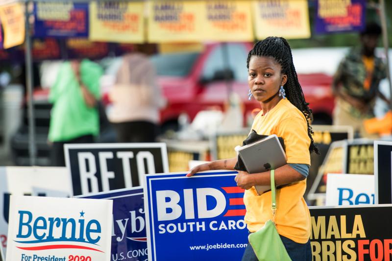 Kanesha Adams stands in the parking lot outside of Jim Clyburn's World-Famous Fish Fry on June 21 in Columbia, S.C. The event featured appearances by 21 Democratic presidential candidates seeking voters in the early primary state. Kanesha Adams stands in the parking lot outside of Jim Clyburn's World-Famous Fish Fry on June 21 in Columbia, S.C. The event featured appearances by 21 Democratic presidential candidates seeking voters in the early primary state.