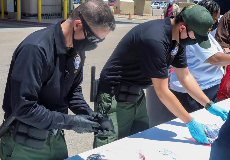 Officials help process and log personal items from migrants entering the Central Processing Center in El Paso, Texas, in this May 4 photo provided by the U.S. Border Patrol. Officials help process and log personal items from migrants entering the Central Processing Center in El Paso, Texas, in this May 4 photo provided by the U.S. Border Patrol.