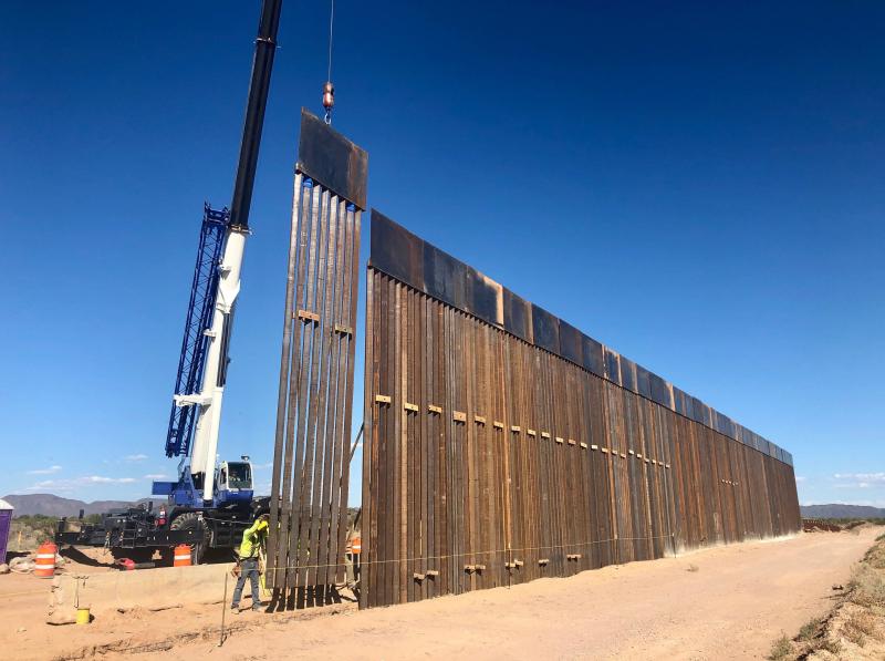 A 30-foot border barrier — as tall as a two-story building — rises from the desert near Lukeville, Ariz. A 30-foot border barrier — as tall as a two-story building — rises from the desert near Lukeville, Ariz.