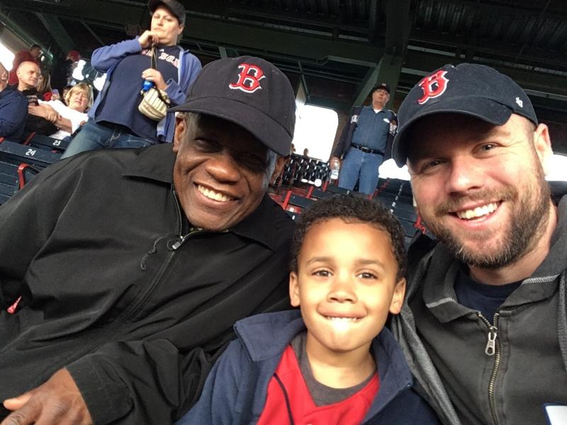 Calvin Hennick (right) attends a Red Sox game with his son, Nile, and his father-in-law, Guy Mont-Louis, at Boston's Fenway Park. Hennick reported a white fan who he said made a racist remark about a Kenyan woman who sang the national anthem. Calvin Hennick (right) attends a Red Sox game with his son, Nile, and his father-in-law, Guy Mont-Louis, at Boston's Fenway Park. Hennick reported a white fan who he said made a racist remark about a Kenyan woman who sang the national anthem.