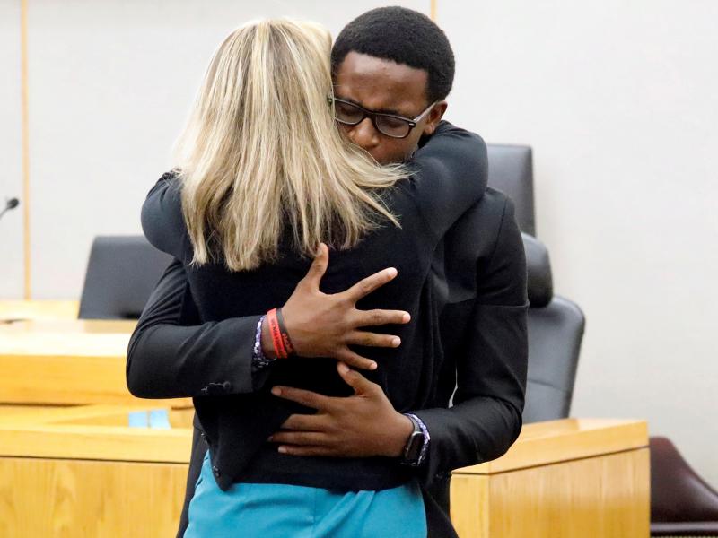 Brandt Jean, Botham Jean's younger brother, hugs former Dallas police officer Amber Guyger in court after saying he forgives her for killing his brother. Guyger received a 10-year prison sentence for murder. Brandt Jean, Botham Jean's younger brother, hugs former Dallas police officer Amber Guyger in court after saying he forgives her for killing his brother. Guyger received a 10-year prison sentence for murder.