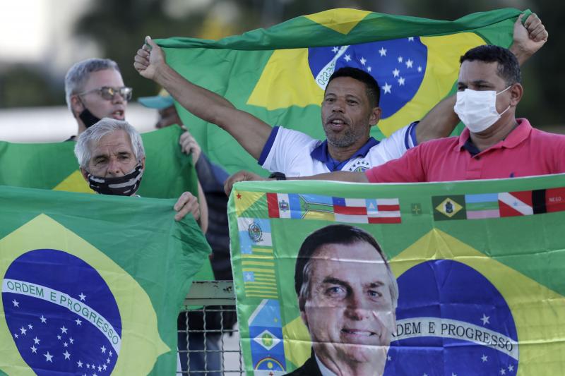 Demonstrators show support for Brazilian President Jair Bolsonaro in front of the presidential palace Monday in Brasilia. Bolsonaro reshuffled his Cabinet amid turmoil in his administration and dropping approval ratings over the coronavirus pandemic. Demonstrators show support for Brazilian President Jair Bolsonaro in front of the presidential palace Monday in Brasilia. Bolsonaro reshuffled his Cabinet amid turmoil in his administration and dropping approval ratings over the coronavirus pandemic.