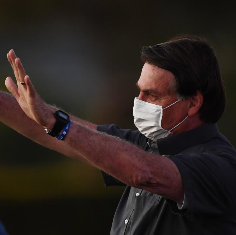 Brazilian President Jair Bolsonaro waves to supporters from the Alvorada Palace in Brasilia on Monday, the same day that two more of his Cabinet ministers were diagnosed with COVID-19. Brazilian President Jair Bolsonaro waves to supporters from the Alvorada Palace in Brasilia on Monday, the same day that two more of his Cabinet ministers were diagnosed with COVID-19.
