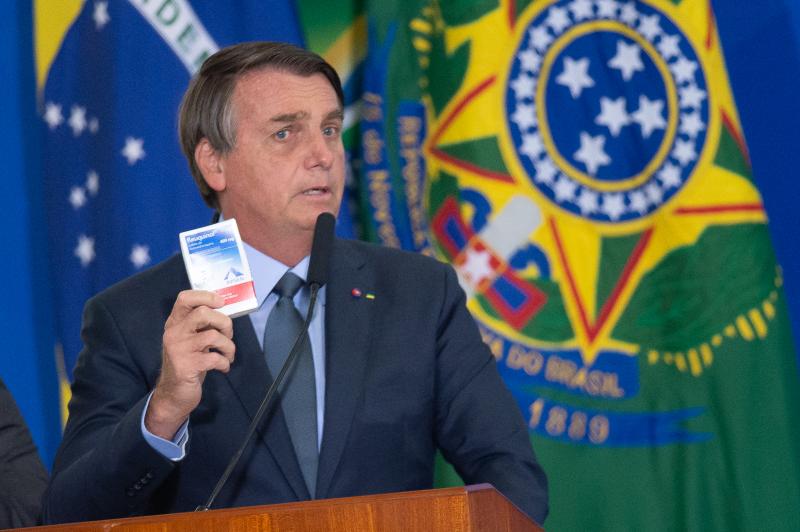Brazilian President Jair Bolsonaro holds up a box of chloroquine, an antimalarial medicine that his administration endorsed as part of an "early treatment" strategy for COVID-19. There is no evidence the drug can prevent the coronavirus or reduce the seve Brazilian President Jair Bolsonaro holds up a box of chloroquine, an antimalarial medicine that his administration endorsed as part of an "early treatment" strategy for COVID-19. There is no evidence the drug can prevent the coronavirus or reduce the seve
