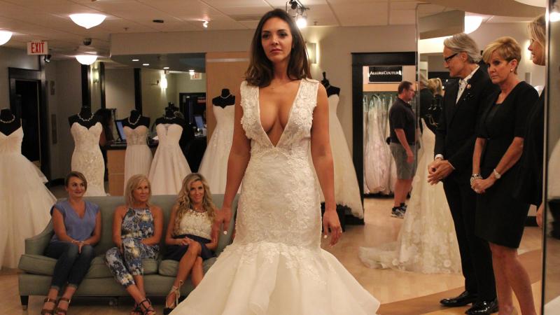 Bride Lindsey Morgan tries on a popular style on an episode of TLC's Say Yes to the Dress Atlanta. Host Monte Durham stands second from right. Bride Lindsey Morgan tries on a popular style on an episode of TLC's Say Yes to the Dress Atlanta. Host Monte Durham stands second from right.