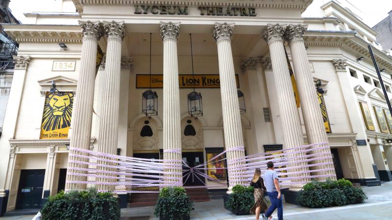 London's Lyceum Theatre is wrapped in pink tape bearing the words "Missing Live Theatre," part of a campaign by a group of British stage designers. London's Lyceum Theatre is wrapped in pink tape bearing the words "Missing Live Theatre," part of a campaign by a group of British stage designers.