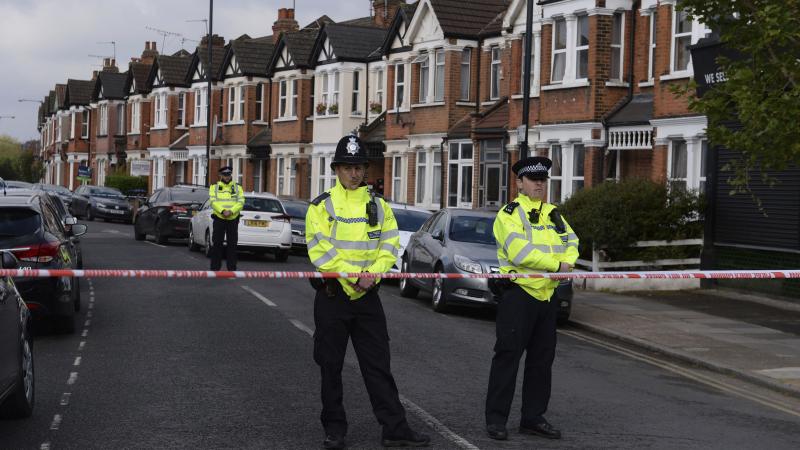 Police cordon off part of London's Harlesden Road on Friday, after counterterrorism police shot a woman and arrested several people in raids in London and southeastern England. Police cordon off part of London's Harlesden Road on Friday, after counterterrorism police shot a woman and arrested several people in raids in London and southeastern England.