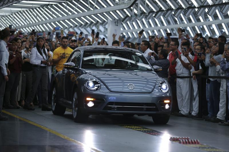 Employees take photos of the Final Edition version of the Volkswagen Beetle, painted "stonewash blue" according to the company, as it rolls out at the production plant in Puebla, Mexico. The last Beetle is not for sale, but destined instead for a museum. Employees take photos of the Final Edition version of the Volkswagen Beetle, painted "stonewash blue" according to the company, as it rolls out at the production plant in Puebla, Mexico. The last Beetle is not for sale, but destined instead for a museum.