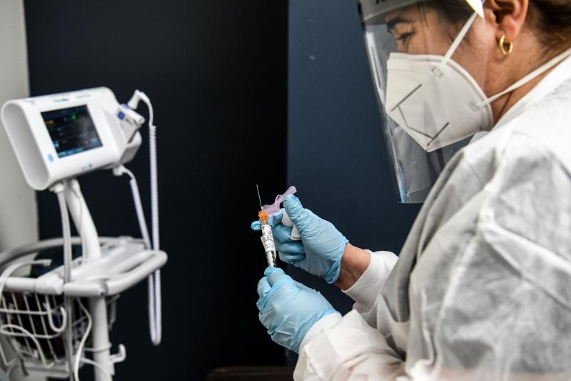 Yaquelin De La Cruz holds a COVID-19 vaccine during clinical trials in August at the Research Centers of America in Hollywood, Fla. Yaquelin De La Cruz holds a COVID-19 vaccine during clinical trials in August at the Research Centers of America in Hollywood, Fla.
