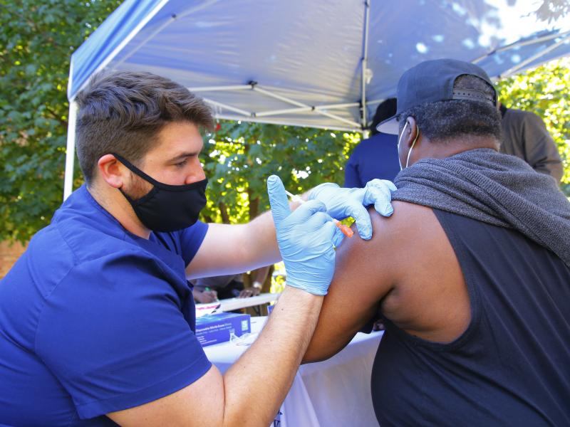 A health care worker administers a Pfizer-BioNTech COVID-19 vaccine Thursday at Life of Hope Center in New York City. A health care worker administers a Pfizer-BioNTech COVID-19 vaccine Thursday at Life of Hope Center in New York City.
