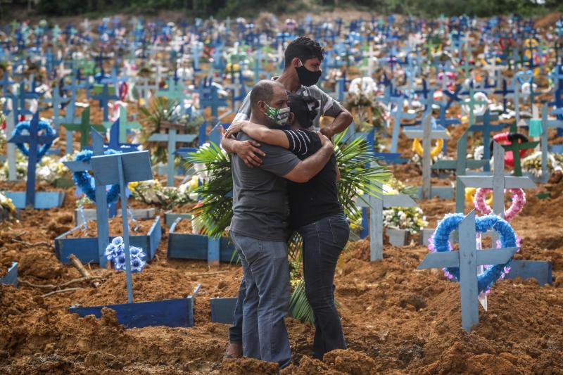 Relatives at a mass burial of pandemic victims at the Parque Taruma cemetery in Manaus, Brazil, mourn a family member. Relatives at a mass burial of pandemic victims at the Parque Taruma cemetery in Manaus, Brazil, mourn a family member.