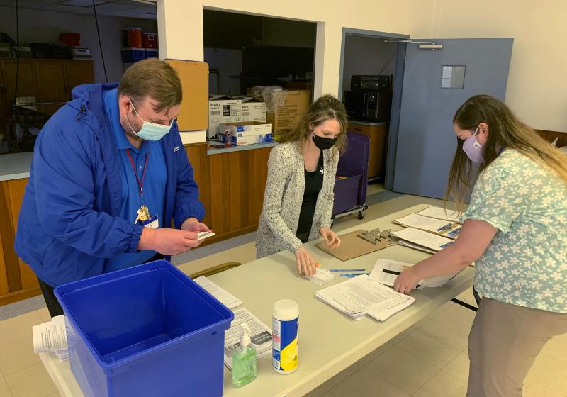 Holmes County, Ohio, General Health District staff members (from left) Michael Derr, Jennifer Talkington and Abbie Benton prepare materials for a COVID-19 vaccine clinic this month inside St. Peter's Catholic Church in Millersburg. Holmes County, Ohio, General Health District staff members (from left) Michael Derr, Jennifer Talkington and Abbie Benton prepare materials for a COVID-19 vaccine clinic this month inside St. Peter's Catholic Church in Millersburg.